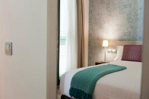 Posteľ alebo postele v izbe v ubytovaní MH Apartments S. Familia