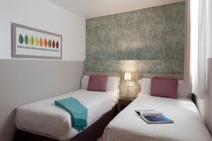 Posteľ alebo postele v izbe v ubytovaní MH Apartments S. Familia