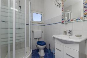 a bathroom with a toilet and a sink at Apartments Marija in Ražanj +30 photos