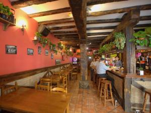 a restaurant with people sitting at a bar at Hostal Rural Elosta in Lekunberri