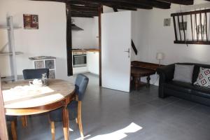 a living room with a table and a couch at Gîte Chevannes in Fours