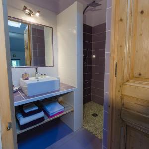 een badkamer met een wastafel en een spiegel bij La Jourdane in Saint-Alexandre