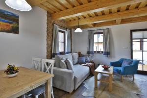 a living room with a couch and a table at Rezort Gothal Chalupy in Donovaly