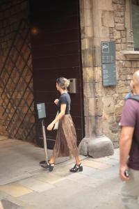 a woman walking in front of a building at Ciutat de Barcelona in Barcelona