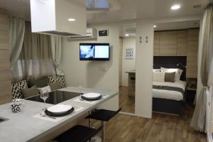 a room with a kitchen and a bedroom with a bed at Baia Holiday Gardasee in Moniga +36 photos