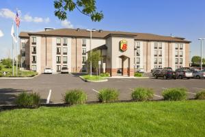 a large building with a parking lot in front of it at Super 8 by Wyndham Mount Laurel in Mount Laurel