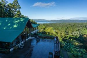 a building with a deck with a view of the ocean at Arenal Observatory Lodge & Trails in Fortuna