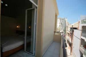 A bed or beds in a room at Lena Hotel