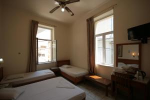 A bed or beds in a room at Lena Hotel