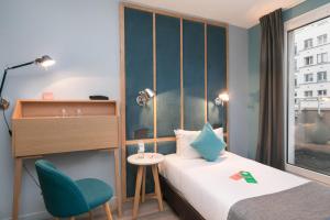 a room with a bed and a desk and a chair at Hôtel Sanso by HappyCulture in Paris