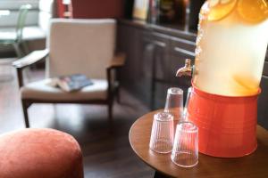 a lamp sitting on a table in a room at Hôtel Sanso by HappyCulture in Paris