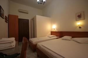 A bed or beds in a room at Lena Hotel