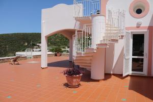 a house with a staircase on the side of it at Le Case dei Pescatori - Villa Domitilla in Ponza