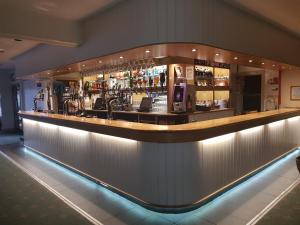 a bar with a long counter with drinks at Vineyard Vale Cottage in Saundersfoot