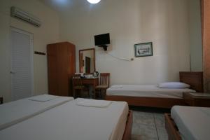 A bed or beds in a room at Lena Hotel