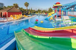 a large swimming pool with a water slide and a playground at Alfagar Alto da Colina in Albufeira