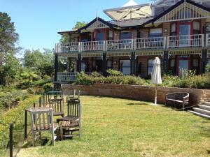 une grande maison avec une pelouse devant elle dans l'établissement Echoes Boutique Hotel & Restaurant Blue Mountains, à Katoomba