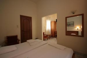 A bed or beds in a room at Lena Hotel