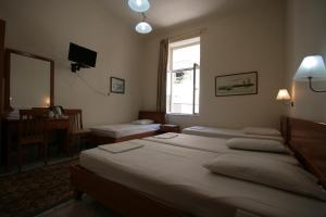 A bed or beds in a room at Lena Hotel