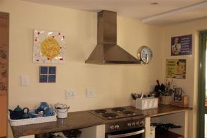 a kitchen with a stove and a counter top at 43 Artemis in Langebaan