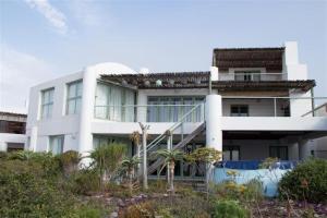 a white building with a staircase in front of it at 43 Artemis in Langebaan