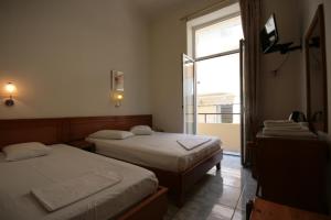 A bed or beds in a room at Lena Hotel