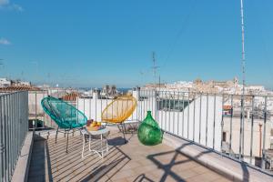 two chairs and a table on a balcony with a view at Arcuève-Dimora con vista CON TERRAZZE PANORAMICHE in Ostuni
