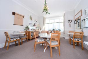 a dining room with a table and chairs at Mory House in Bournemouth