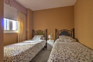 Posteľ alebo postele v izbe v ubytovaní Apartamentos Aloha2 El Puerto de Santa Maria