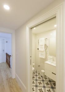 a bathroom with a sink and a mirror at Mercado dos Poetas – Tourism Apartments in Porto