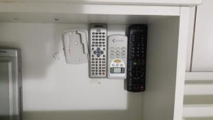 a group of remote controls sitting on a shelf at Park Studio in Brasilia