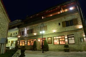 a brick building with a street light in front of it at Anesis Hotel in Kalavrita