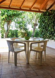 a white table and chairs on a patio at Nireas Studios & Aparts in Acharavi