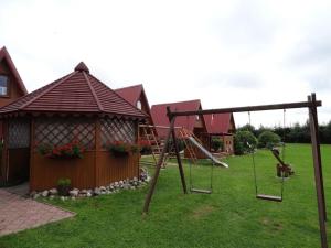 a playground in a yard with a swing at 7 Dziewczyn in Dźwirzyno