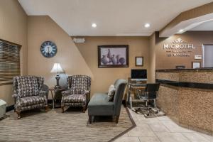 a waiting room at a hospital with chairs and a counter at Microtel Inn & Suites by Wyndham Rochester North Mayo Clinic in Rochester