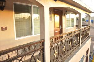 a balcony of a house with a wrought iron railing at Sun Light Motel in Downey