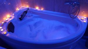 a bathroom with a tub with lights in it at Petreski Apartments 1 in Ohrid +170 photos