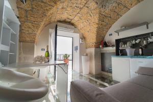 a kitchen with a table and a couch in a room at Suite ortigia vista mare in Syracuse