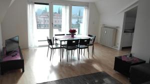 a dining room with a table and chairs in a living room at Boschetto in Riva del Garda