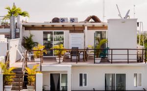 a balcony of a house with plants on it at Casa Luca in Playa del Carmen