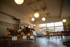 a large room with tables and chairs and lights at Mountain Home Lodge in Deer Park in Nara +30 photos