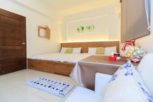 Postel nebo postele na pokoji v ubytování Yilan Dongshan Cypress B&B