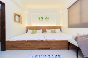 Postel nebo postele na pokoji v ubytování Yilan Dongshan Cypress B&B