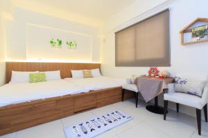 Postel nebo postele na pokoji v ubytování Yilan Dongshan Cypress B&B