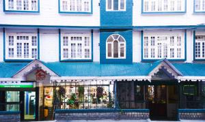 a blue and white building with a store at The Nettle and Fern Hotel Gangtok in Gangtok