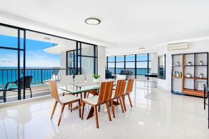 a dining room with a view of the ocean at ULTIQA Beach Haven on Broadbeach in Gold Coast