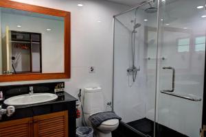 a bathroom with a shower and a toilet and a sink at Pool Access 89 @Rawai Hotel in Rawai Beach
