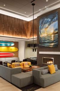 a living room with a couch and a fireplace at Hyatt Place Santa Cruz in Santa Cruz