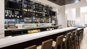 a bar in a restaurant with a row of chairs at Hyatt House Washington DC/The Wharf in Washington +29 photos