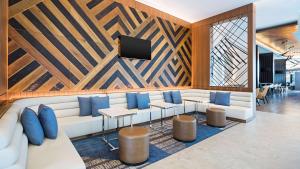 a lobby with a white couch and blue pillows at Hyatt House Washington DC/The Wharf in Washington